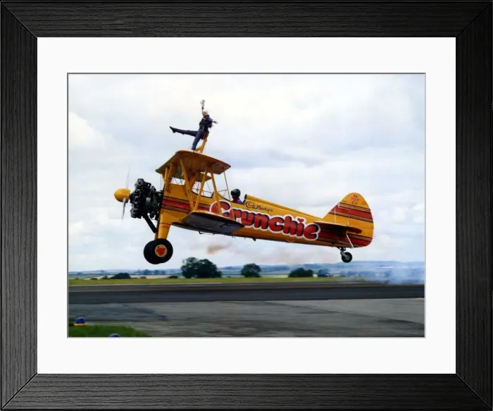 Framed Print : A Cadburys Crunchie Boeing-Stearman Model 75 biplane, with wing walker onboard Framed Print : A Cadburys Crunchie Boeing-Stearman Model 75 biplane, with wing walker onboard