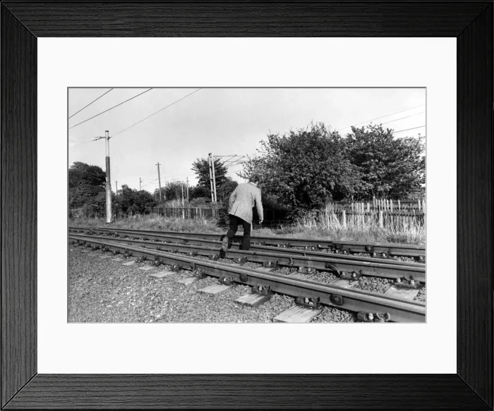 Framed Print : A man crossing the railway line illegally on 13th May 1981 Framed Print : A man crossing the railway line illegally on 13th May 1981