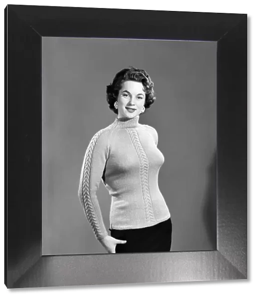 Clothing: Fashion: Knitwear: Model wearing jumper. 1955