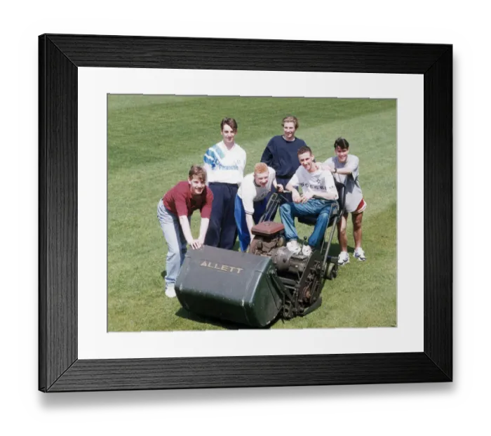 Framed Print : Manchester United youth team players surrounding a lawnmower on the pitch at The Cliff