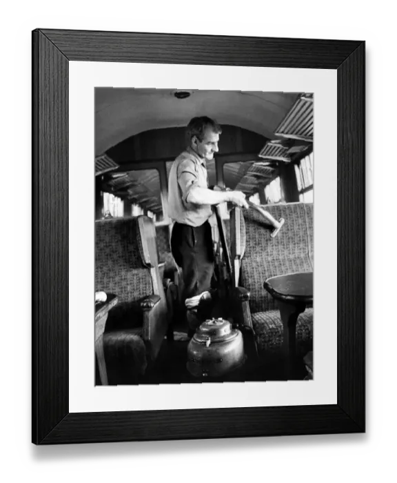 Framed Print : Mr. Frank Baley vacuums seats while cleaning a carriage ready for another journey on 10th Framed Print : Mr. Frank Baley vacuums seats while cleaning a carriage ready for another journey on 10th