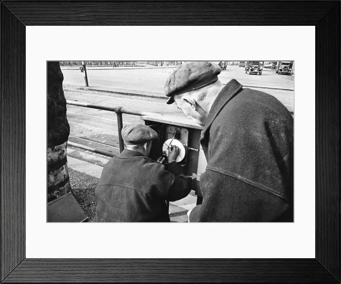 Framed Print : Edward Farmer and assistant seen here checking a sewage flow meter on the embankment
