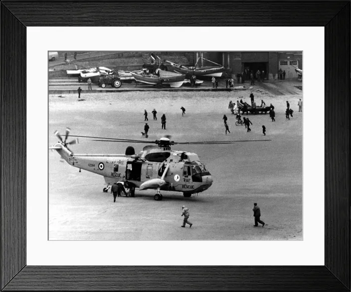 Framed Print : A RAF search and rescue Sea King from RAF Boulmer lands a man on the beach after he was