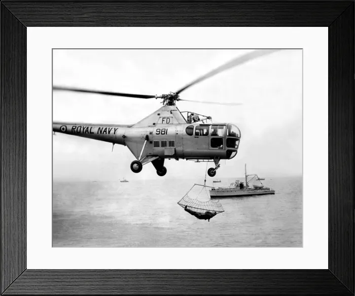 Framed Print : A Royal Navy Westland Dragonfly helicopter uses the newly developed scoop net for picking Framed Print : A Royal Navy Westland Dragonfly helicopter uses the newly developed scoop net for picking