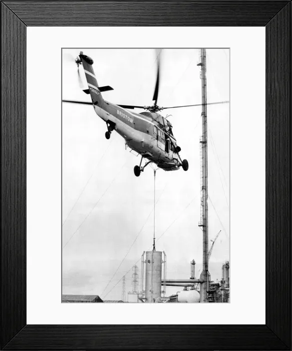 Framed Print : A Westland Wessex helicopter, operated by Bristow, tackles the job of airlifting the tip Framed Print : A Westland Wessex helicopter, operated by Bristow, tackles the job of airlifting the tip
