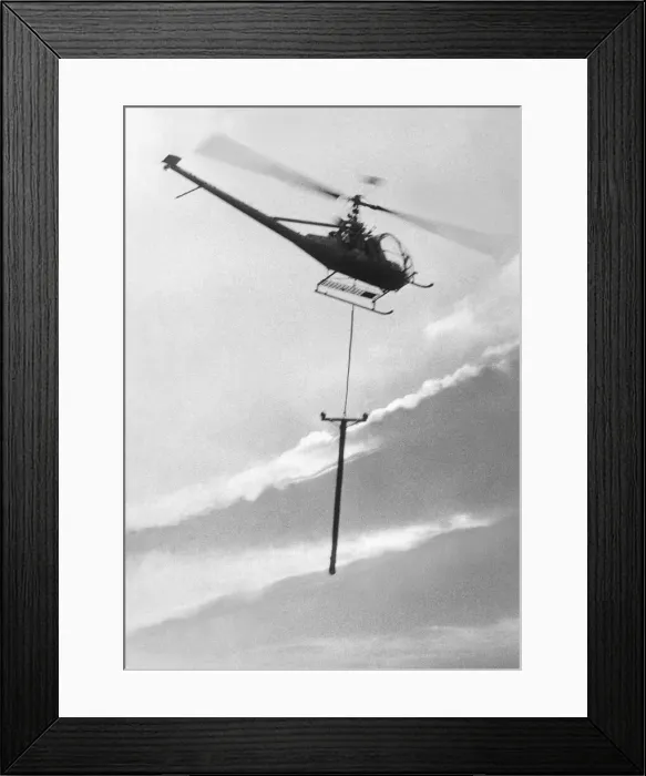 Framed Print : A Hiller 12E helicopter carries a telegraph pole across Grouse Moor at Kings Law Framed Print : A Hiller 12E helicopter carries a telegraph pole across Grouse Moor at Kings Law
