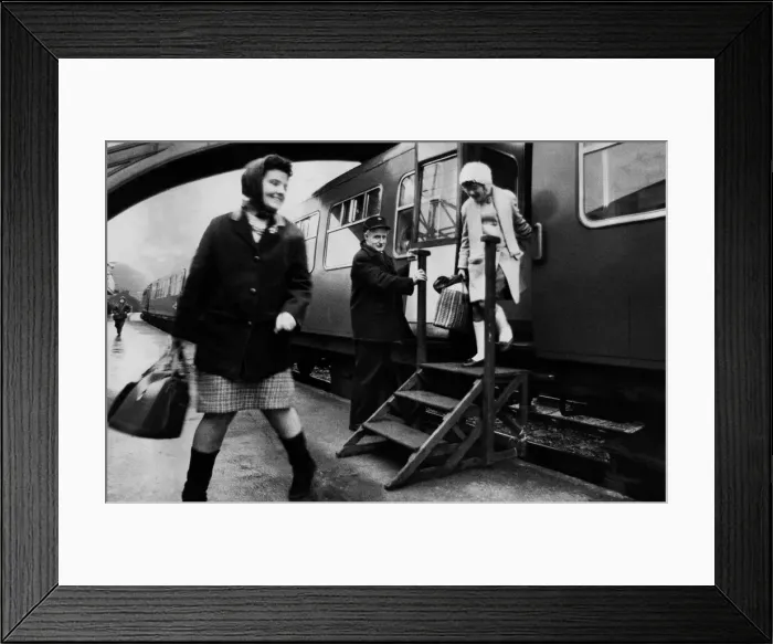 Framed Print : Mr. William Hodgson, porter at Stocksfield station, fixes the portable steps to a Framed Print : Mr. William Hodgson, porter at Stocksfield station, fixes the portable steps to a