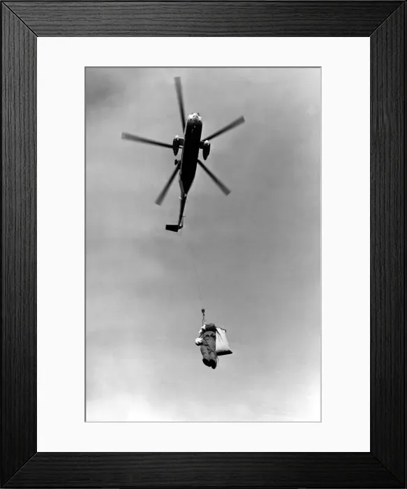 Framed Print : A RAF Sea King helicopter lowers Father Christmas to the ground