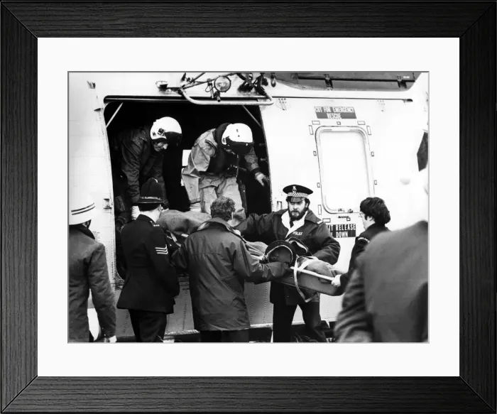 Framed Print : A RAF search and rescue Sea King helicopter from RAF Boulmer airlifts an injured man to