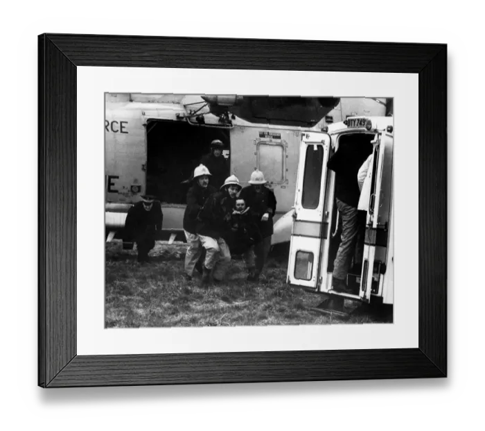 Framed Print : A RAF search and rescue Sea King from RAF Boulmer lands a man Framed Print : A RAF search and rescue Sea King from RAF Boulmer lands a man