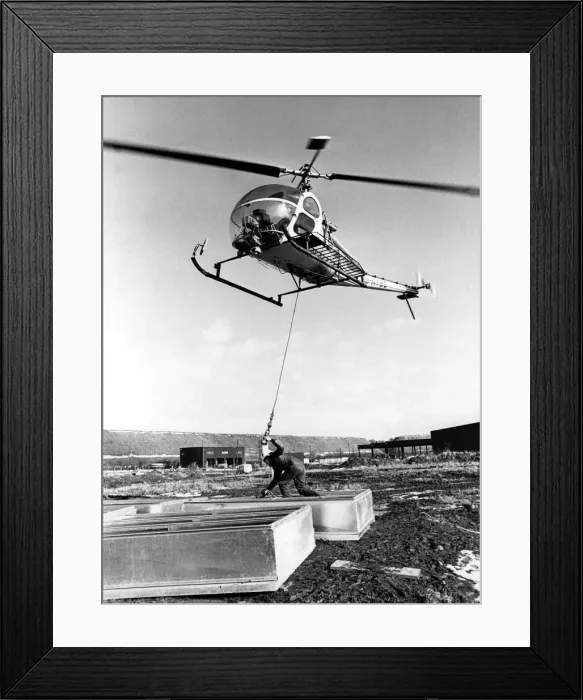 Framed Print : A Hiller UH-12 helicopter was called into lift 48 smoke ventilators onto the roof of a