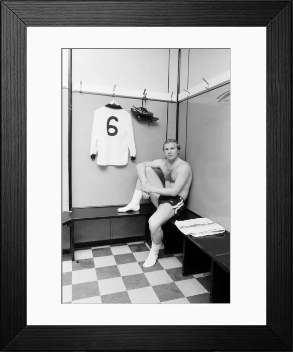Framed Print : Fulham footballer Bobby Moore sits alone in the dressing room at Craven Cottage with his Framed Print : Fulham footballer Bobby Moore sits alone in the dressing room at Craven Cottage with his