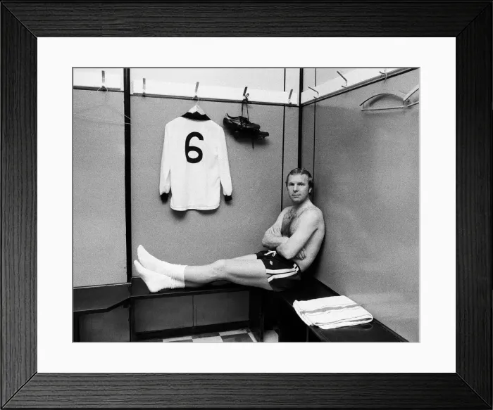 Framed Print : Fulham footballer Bobby Moore sits alone in the dressing room at Craven Cottage with his Framed Print : Fulham footballer Bobby Moore sits alone in the dressing room at Craven Cottage with his
