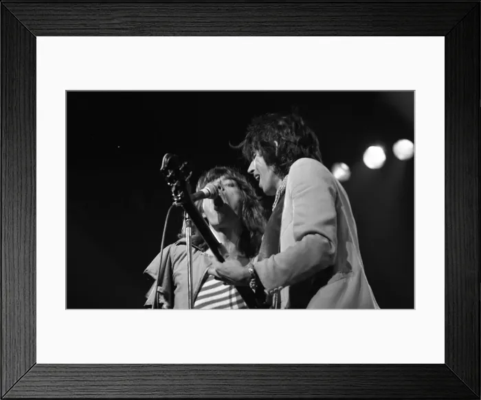 Framed Print : Mick Jagger and guitasrist Bill Wyman performing on stage during a Rolling Stones concert