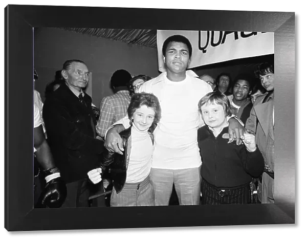 Mohammed Ali seen here with two young fight fans at Quaglinos Restaurant