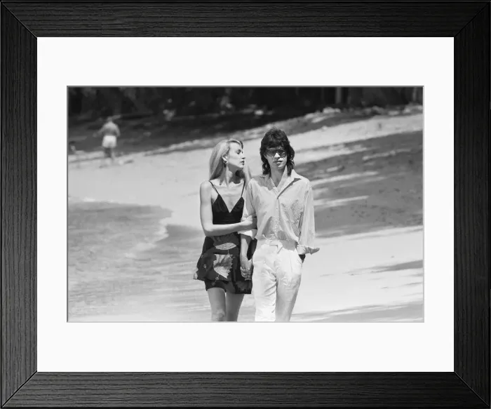 Framed Print : Mick Jagger and Jerry Hall seen here taking a stroll along the beach at Gibbs Bay in Framed Print : Mick Jagger and Jerry Hall seen here taking a stroll along the beach at Gibbs Bay in