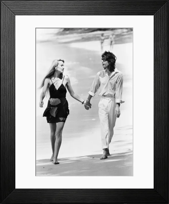 Framed Print : Mick Jagger and Jerry Hall seen here taking a stroll along the beach at Gibbs Bay in Framed Print : Mick Jagger and Jerry Hall seen here taking a stroll along the beach at Gibbs Bay in