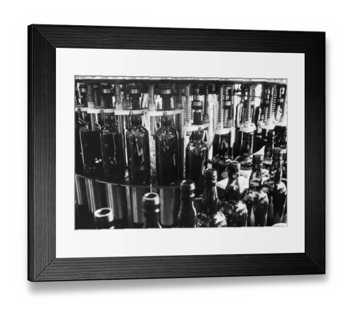 Framed Print : The Real Scotch Whisky - An automatic filling machine at the bottling plant