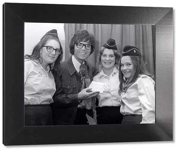 A young Cliff Richard receiving a cheque for £61 that has been presented for