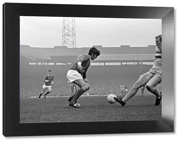 Manchester United footballer George Best faced by Bobby Moore of West Ham during