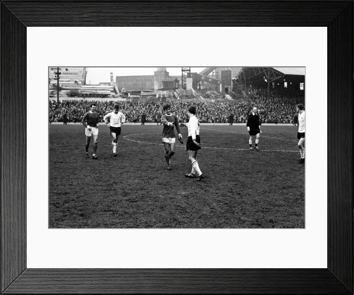 Framed Print : Manchester United footballer George Best with a football boot in his hand