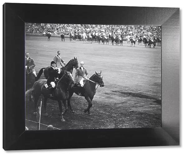 Pat Smythe and two other members of the British Team ride past the Royal box at