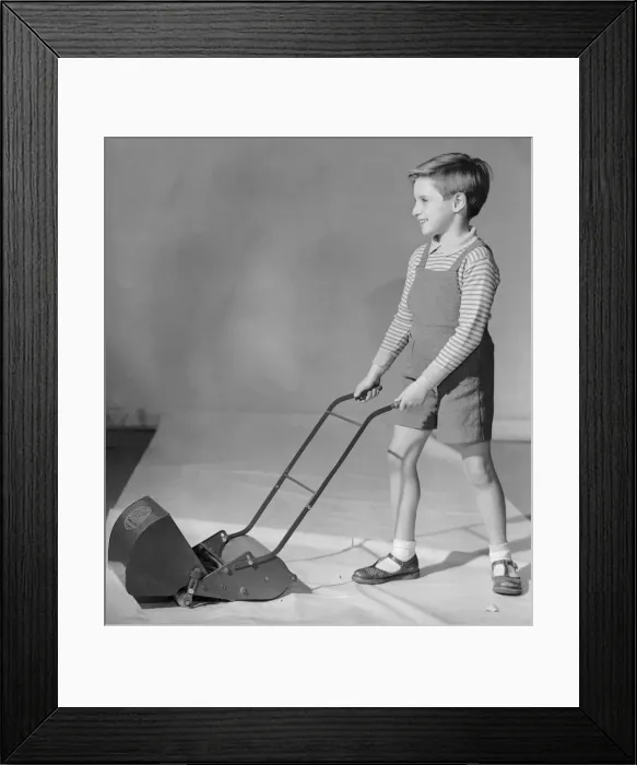 Framed Print : Schoolboy seen here playing with a toy lawn mower 2nd December 1957 Framed Print : Schoolboy seen here playing with a toy lawn mower 2nd December 1957
