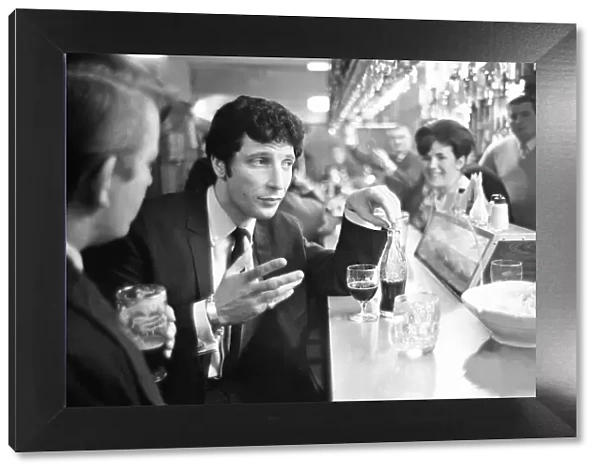 Tom Jones, enjoys a drink, 22nd February 1965