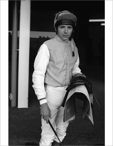 American jockey Steve Cauthen carrying his saddle and whip at Kempton Park, July 1987