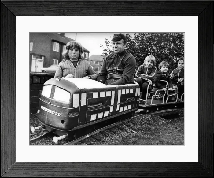 Framed Print : Mr. Arnold Dean and his son Tony, left, driving their 18 inch high fibreglass electric Framed Print : Mr. Arnold Dean and his son Tony, left, driving their 18 inch high fibreglass electric