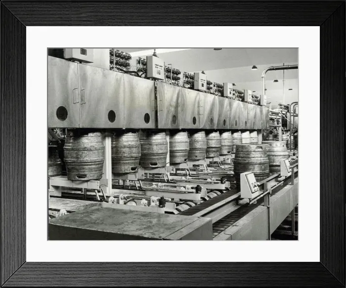 Framed Print : Ansells Brewery. Beer kegs being filled, and full ones discharged
