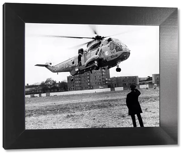 A policeman looks on as a RAF search and rescue Sea King helicopter from RAF Boulmer
