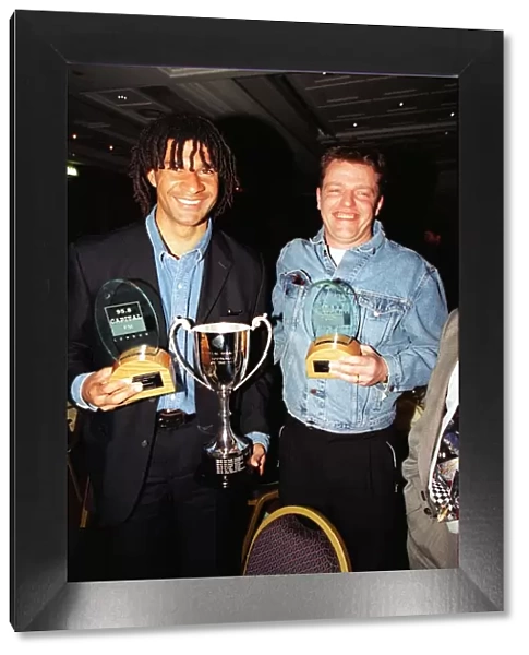 Former footballer Ruud Gullit (left) poses with Madness lead singer Suggs holding their