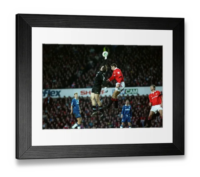 Framed Print : Everton goalkeeper Neville Southall catches the ball with Eric Cantona jumping Manchester Framed Print : Everton goalkeeper Neville Southall catches the ball with Eric Cantona jumping Manchester