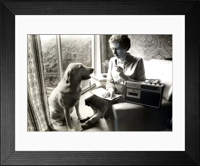 Framed Print : Blind Cardiff City Councillor Joan Ward, recording her notes while her guide dog Jenny