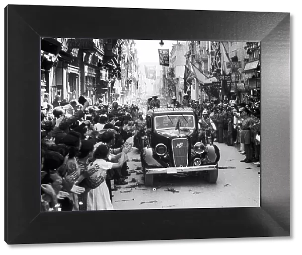 King George VI cheered by waving crowds on the streets of Valetta as he visits
