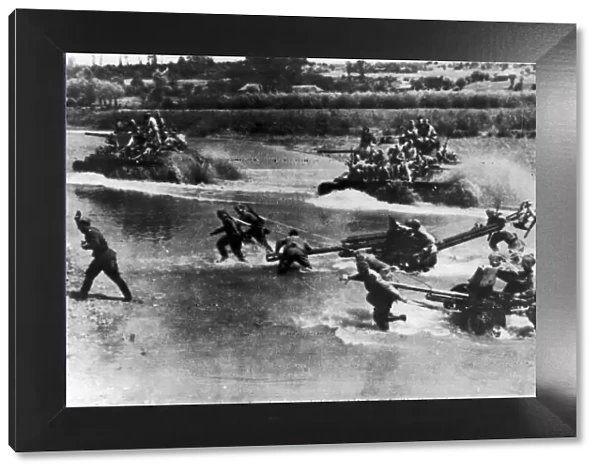 Artillery and tanks of the Russian Red Army force a river crossing in the Soviet advance