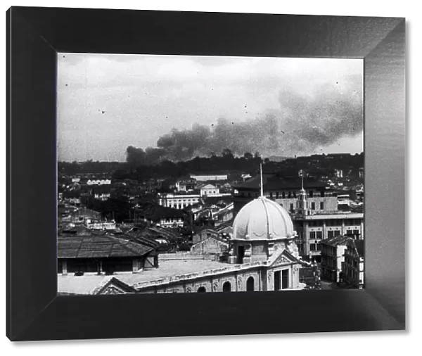 Last days of Singapore. A picture showing smoke rising over Singapore during a Japanese