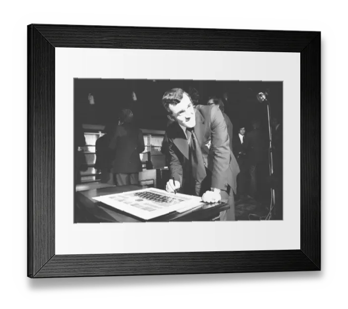 Framed Print : Phil Bennett signing the visitors book at the International Sports Writers Club in Great