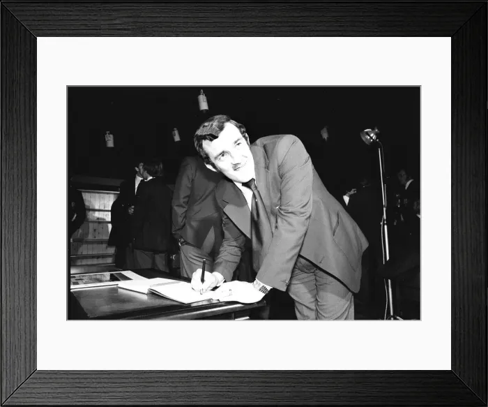 Framed Print : Phil Bennett signing the visitors book at the International Sports Writers Club in Great Framed Print : Phil Bennett signing the visitors book at the International Sports Writers Club in Great