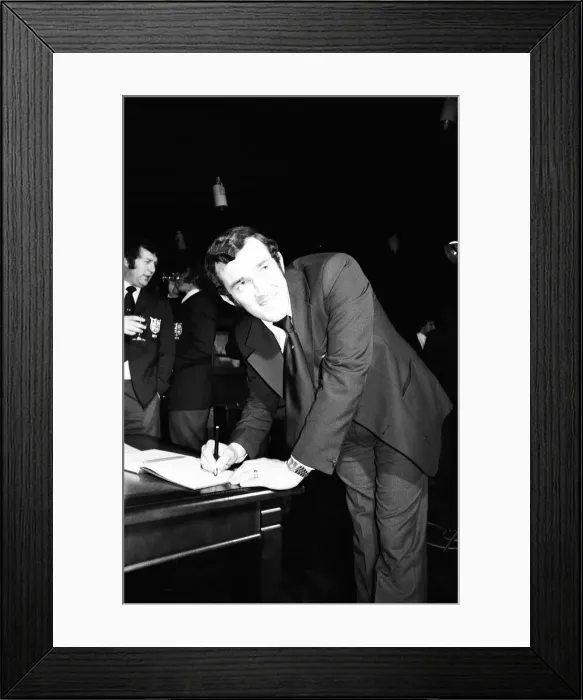 Framed Print : Phil Bennett signing the visitors book at the International Sports Writers Club in Great