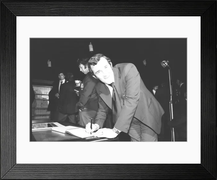 Framed Print : Phil Bennett signing the visitors book at the International Sports Writers Club in Great Framed Print : Phil Bennett signing the visitors book at the International Sports Writers Club in Great