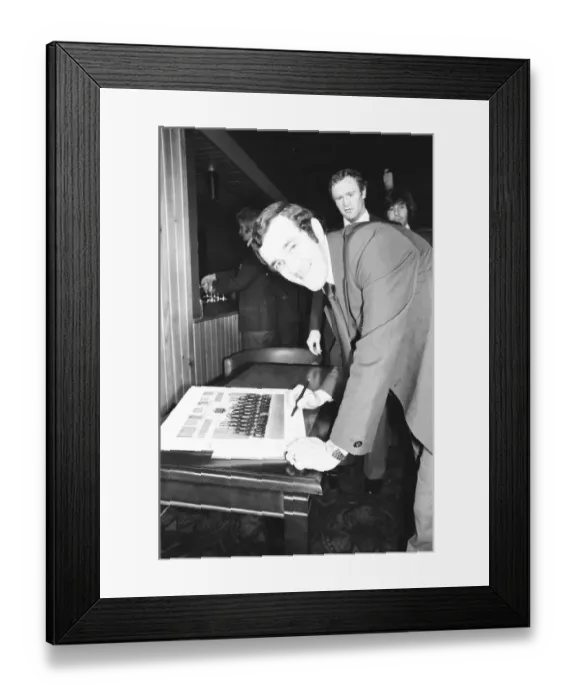 Framed Print : Phil Bennett signing the visitors book at the International Sports Writers Club in Great Framed Print : Phil Bennett signing the visitors book at the International Sports Writers Club in Great