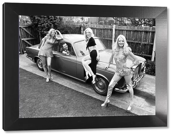 Reg Varney, actor, poses with three models, Lia, Flanagan and Vee Brooks