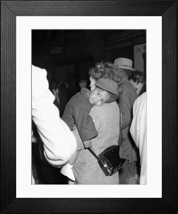 Framed Print : One tired little traveller gets a helping hand from his mother Framed Print : One tired little traveller gets a helping hand from his mother