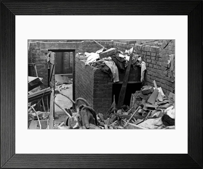 Framed Print : A surface air raid shelter in a backyard which was undamaged when a bomb wrecked a house Framed Print : A surface air raid shelter in a backyard which was undamaged when a bomb wrecked a house