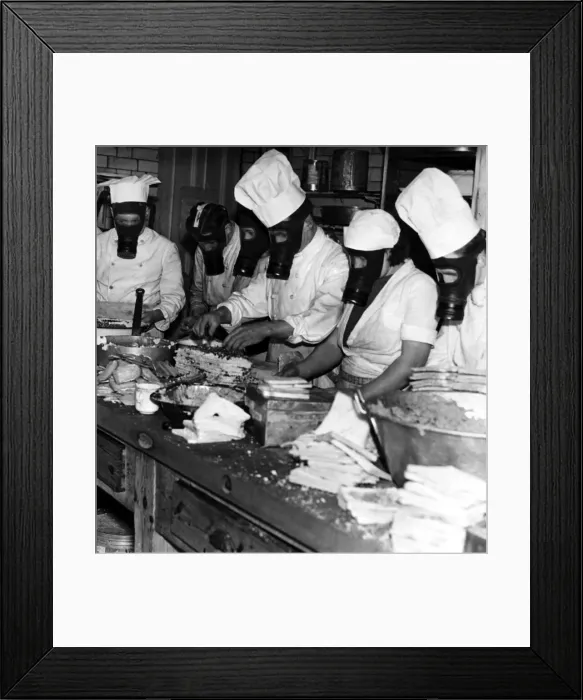 Framed Print : Members of the kitchen staff preparing meals while wearing gas masks during an exercise Framed Print : Members of the kitchen staff preparing meals while wearing gas masks during an exercise