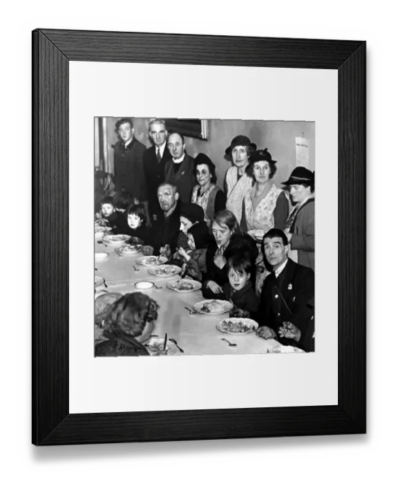 Framed Print : Families enjoy a hot meal at an emergency centre. They had been rendered homeless from a Framed Print : Families enjoy a hot meal at an emergency centre. They had been rendered homeless from a