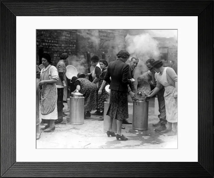 Framed Print : Volunteer workers prepare a meal for families rendered homeless by an air raid