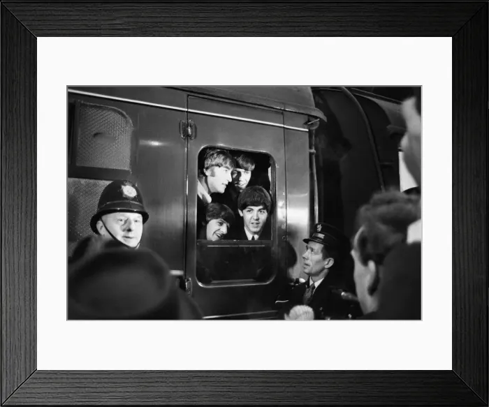 Framed Print : The Beatles peer from a train carriage window at Paddington Station, London Framed Print : The Beatles peer from a train carriage window at Paddington Station, London